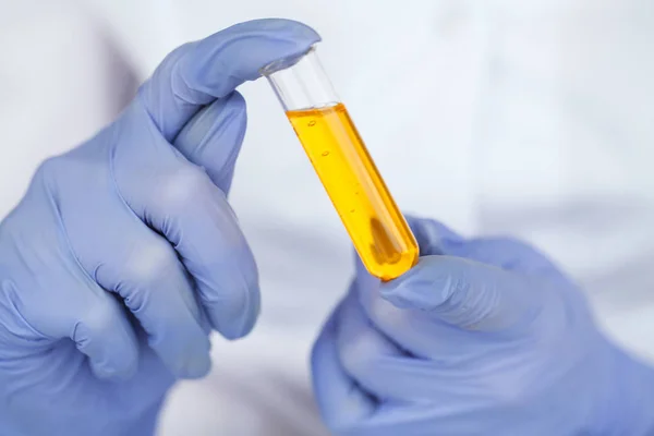 Biological test. Woman holding flask in lab. The scientist,dermatologist testing the organic natural product in the laboratory