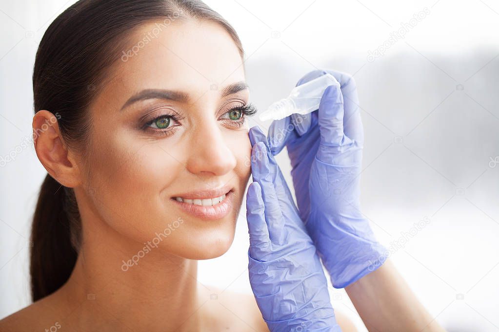 Health and Beauty. Eye Care. Beautiful Young Woman Holding Drops For Eyes. Good Vision. Happy Girl with Fresh Look