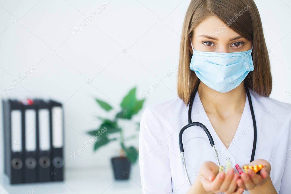 Doctor holding pills on hand. Medicine and health care concept