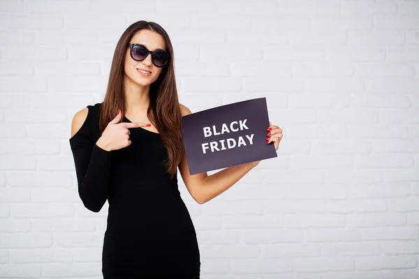 Shopping. Women holdingdiscount blanks on ligth background in black friday holiday — Stock Photo, Image