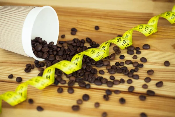 Good Morning. Coffee To Go. Coffee Cups With Cover and Coffee Beans on Wooden Table Backound