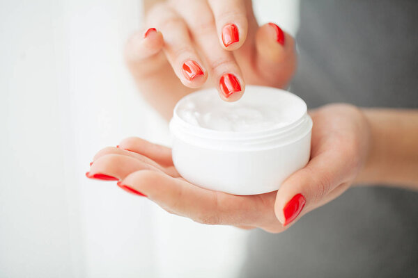 Hand Skin Care. Close Up Of Female Hands Holding Cream Tube, Beautiful Woman Hands With Natural Manicure Nails Applying Cosmetic Hand Cream On Soft Silky Healthy Skin