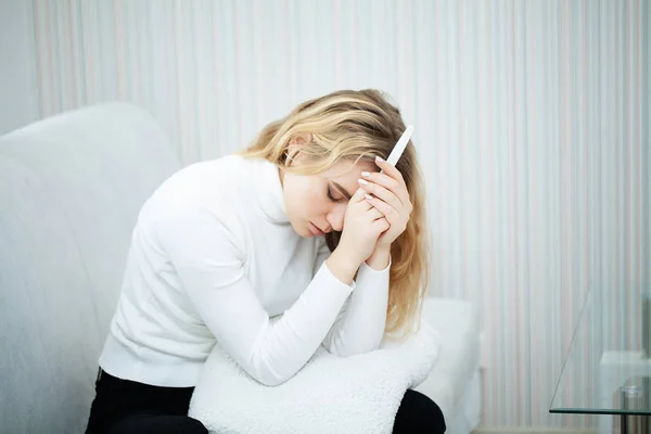 Test di gravidanza positivo. Giovane donna si sente depressa e triste dopo aver guardato il risultato del test di gravidanza a casa — Foto Stock
