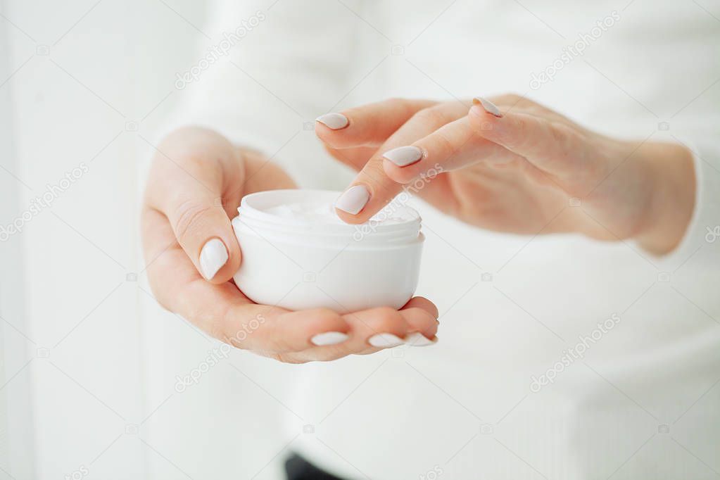 Hand Skin Care. Close Up Of Female Hands Holding Cream Tube, Beautiful Woman Hands With Natural Manicure Nails Applying Cosmetic Hand Cream On Soft Silky Healthy Skin