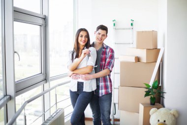 Yeni ev. Komik genç çift zevk ve yeni eve taşıdıktan kutluyor. Boş oda mutlu çifte yeni ev