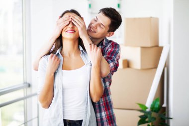 Yeni ev. Komik genç çift zevk ve yeni eve taşıdıktan kutluyor. Boş oda mutlu çifte yeni ev