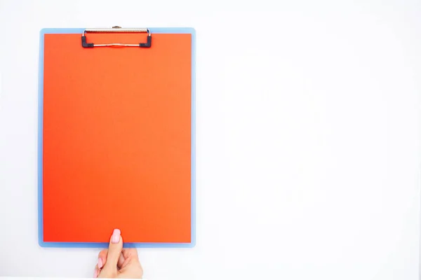 Blank Folder with Red Paper. Hand that Holding Folder and Pen on White Background. Copyspace. Place for Text