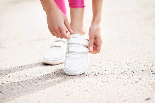 Fitness. Woman Runner Tightening Shoe Lace. Runner Woman Feet Running On Road Closeup On Shoe