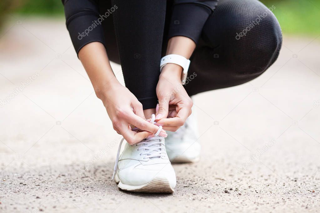 Fitness. Woman Runner Tightening Shoe Lace. Runner Woman Feet Running On Road Closeup On Shoe