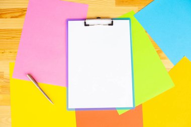 Office el a ağıl ile beyaz renk kağıt ve kalem ahşap masa renkli arka plan üzerinde tutarak. Boşaltmak. Metin için yer