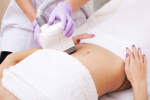 Body Care. Woman is in the process at the clinic lipomassage