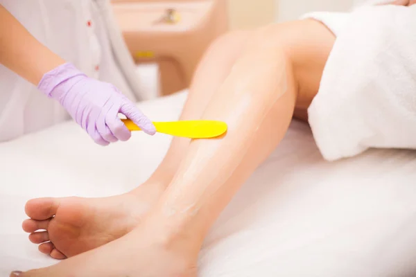 Skin Care. Hair removal on the legs, laser procedure at clinic. Beautician removes hair on beautiful female legs using a laser