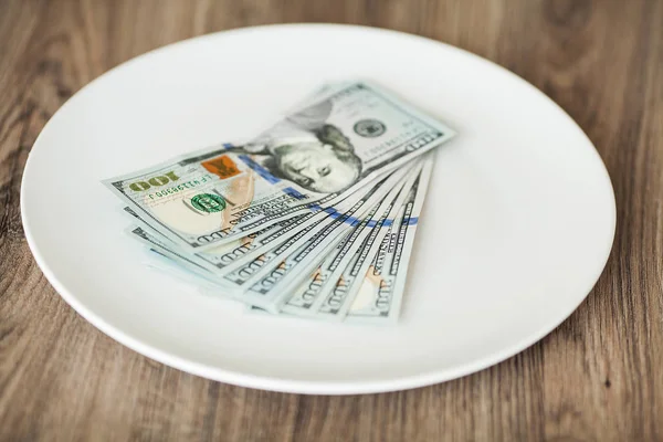 Plate with money. Greedy corruption concept. Bribe idea