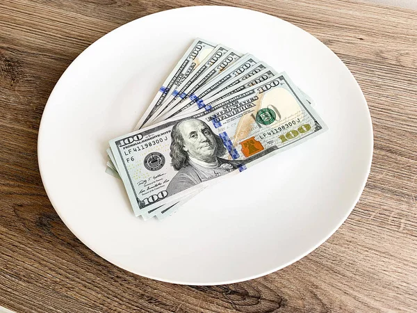 Plate with money. Dollars photo. Greedy corruption concept. Bribe idea