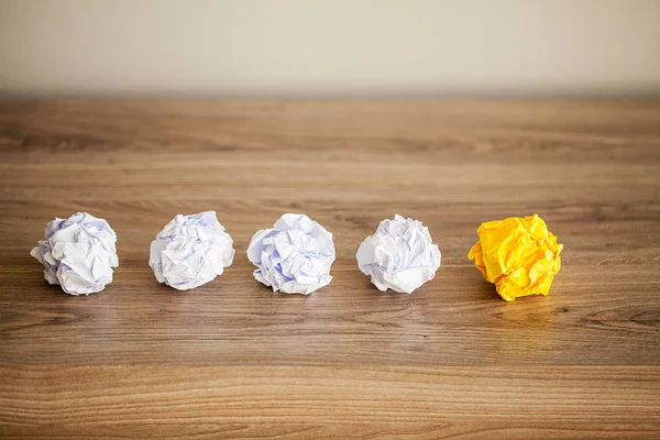 Great idea concept. Crumpled colorful paper on wooden table