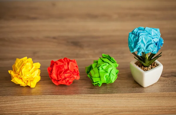 Great idea concept. Crumpled colorful paper on wooden table