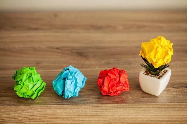 Great idea concept. Crumpled colorful paper on wooden table