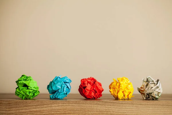 Great idea concept. Crumpled colorful paper on wooden table. Copy space