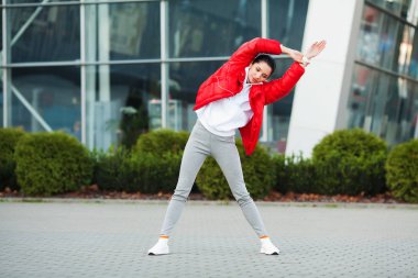 Fitness kadının Stadyumu arka plan ayakta egzersiz yapması