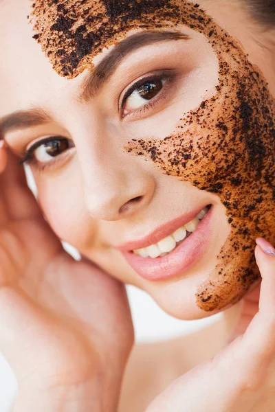 Face Skin Scrub. Smiling Girl Applying Coffee Mask Scrub On Skin