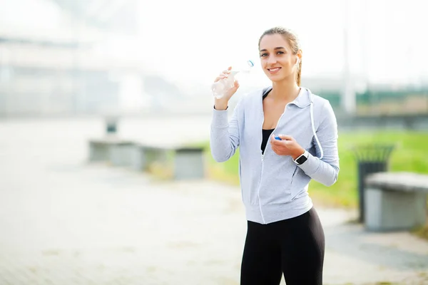 Sports woman after sports exercises in the urban environment