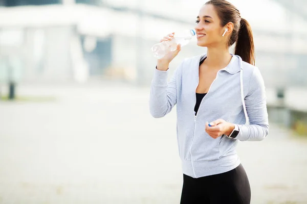 Sports woman after sports exercises in the urban environment