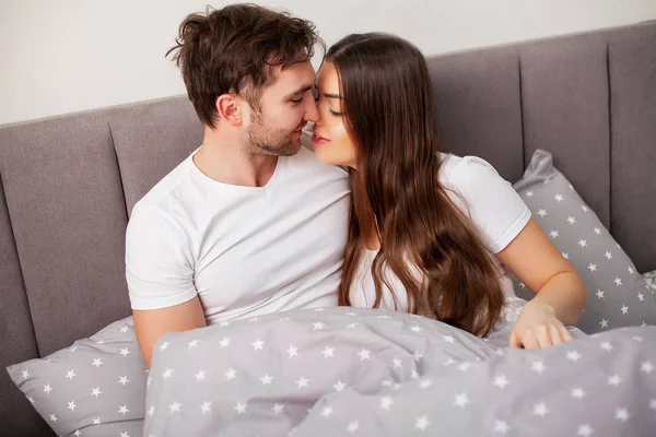 Happy par ha kul i sängen. Intim sensuell ungt par i sovrummet njuter av varandra — Stockfoto