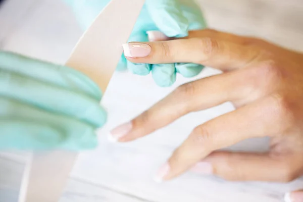 SPA manicure. French manicure at spa salon. Woman hands in a nail salon receiving a manicure procedure