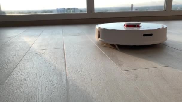 Ett smart hem. Robot dammsugare utför automatisk rengöring av lägenheten vid en viss tidpunkt — Stockvideo