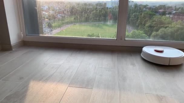 Slim huis. Robot stofzuiger voert automatische reiniging van het appartement op een bepaald moment — Stockvideo