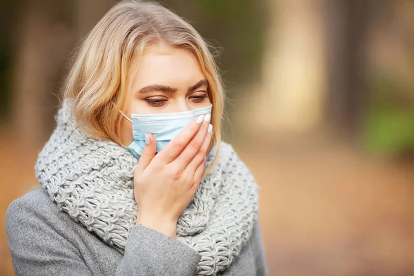 Cold and flu. Woman with a medical face mask at outdoor