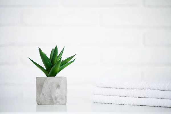 White towels on white table with copy space on bath room background