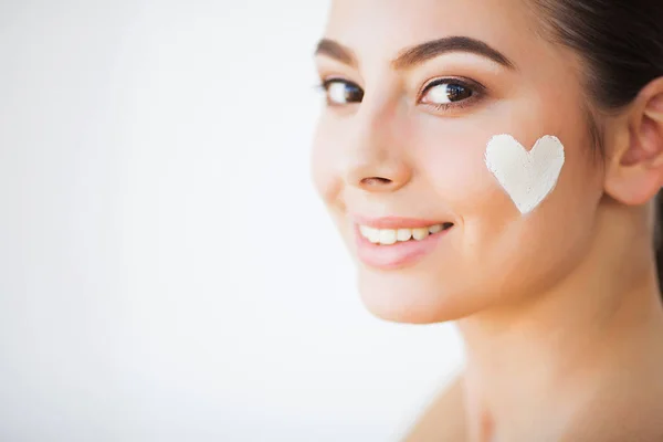Skin Care. Beautiful model applying cosmetic cream treatment on her face — Stock Photo, Image