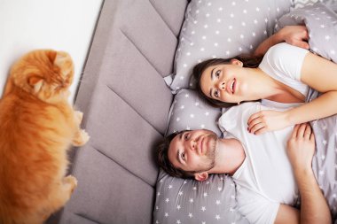 Mutlu çift yatakta eğlenmek. Birbirlerine zevk yatak odasında samimi şehvetli genç çift