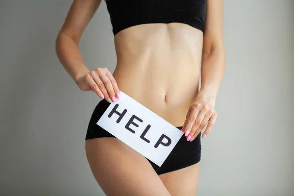 Woman Health Problem. Closeup Of Female With Fit Slim Body In Panties Holding White Card With Word Help Near Her Stomach. Digestive Disorders, Period Pain, Health Issues Concept.