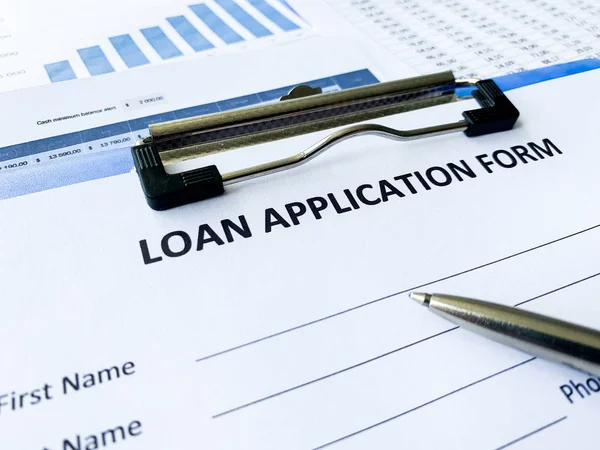 Loan application form document with graph on table Royalty Free Stock Photos