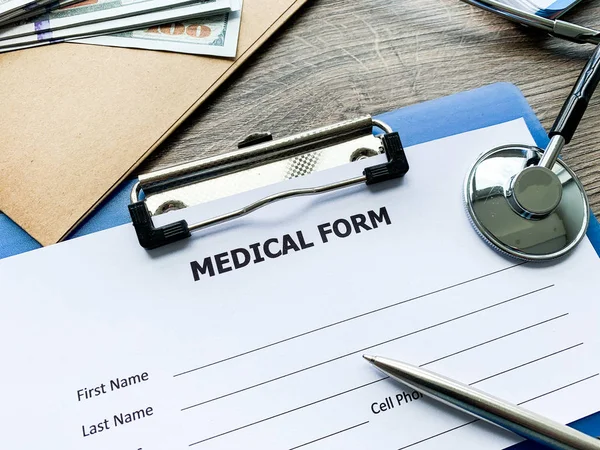 Medical form with patient data on doctors desk