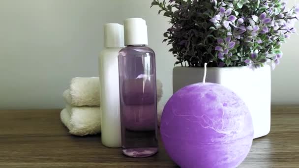 Towels and shower gel on white table with copy space on bath room background. — Stock Video