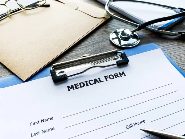 Medical form with patient data on doctors desk