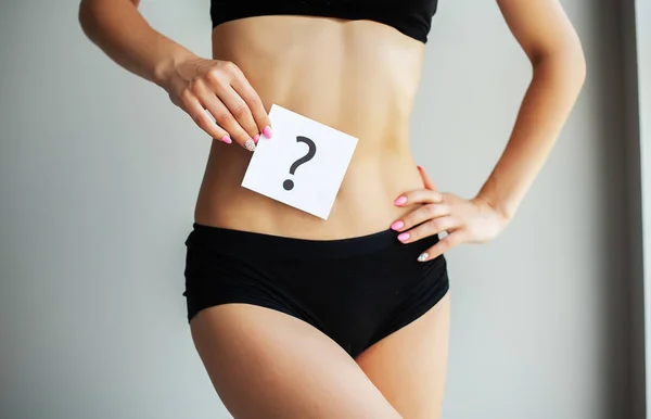 Health. Woman Body In Underwear With Question Card Near Belly