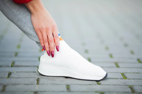 Fitness. Woman Runner Tightening Shoe Lace. Runner Woman Feet Running On Road Closeup On Shoe