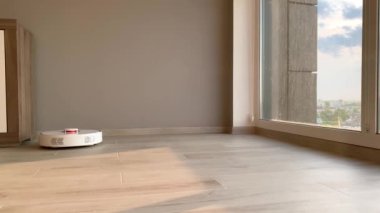 Akıllı ev. Robot elektrikli süpürge daireyi belli bir zamanda otomatik olarak temizliyor.