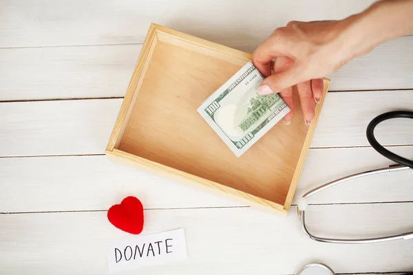 Donations and Charity. Donation Concept. Box of Donations and Heart on the White Background.