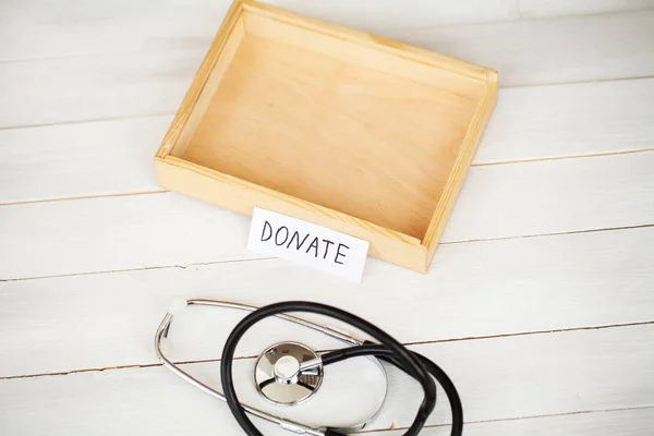 Donations and Charity. Donation Concept. Box of Donations and Heart on the White Background.