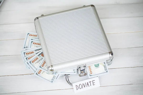 Donation Concept. Case with Dollars on White Background. Donations