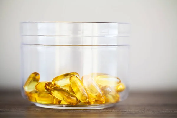 Vitamins supplements, fish oil in yellow capsules omega 3.