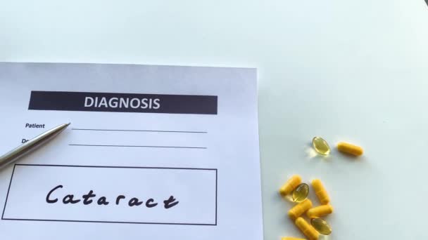 Diagnose Grauer Star in medizinischer Form auf dem Arzttisch. — Stockvideo