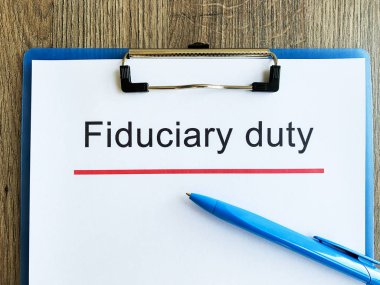 Paper with text fiduciary duty on wood table. clipart