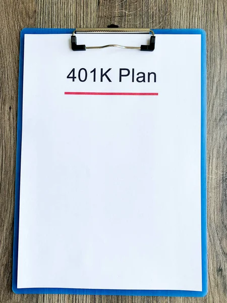 Paper with 401k plan on wood table