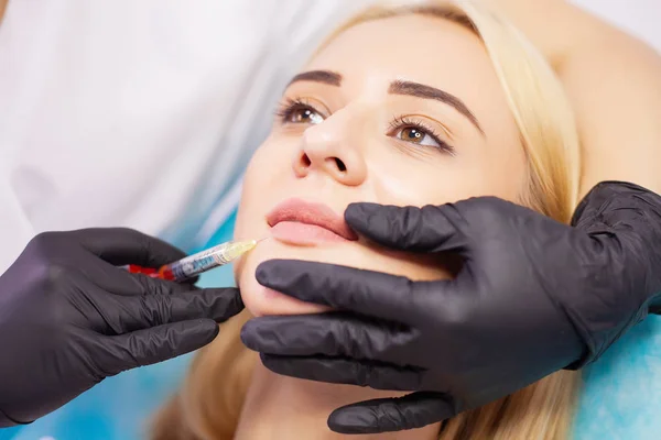 Lip Augmentation In Cosmetology Clinic. Beautiful Woman Getting Beauty Injection For Lips.